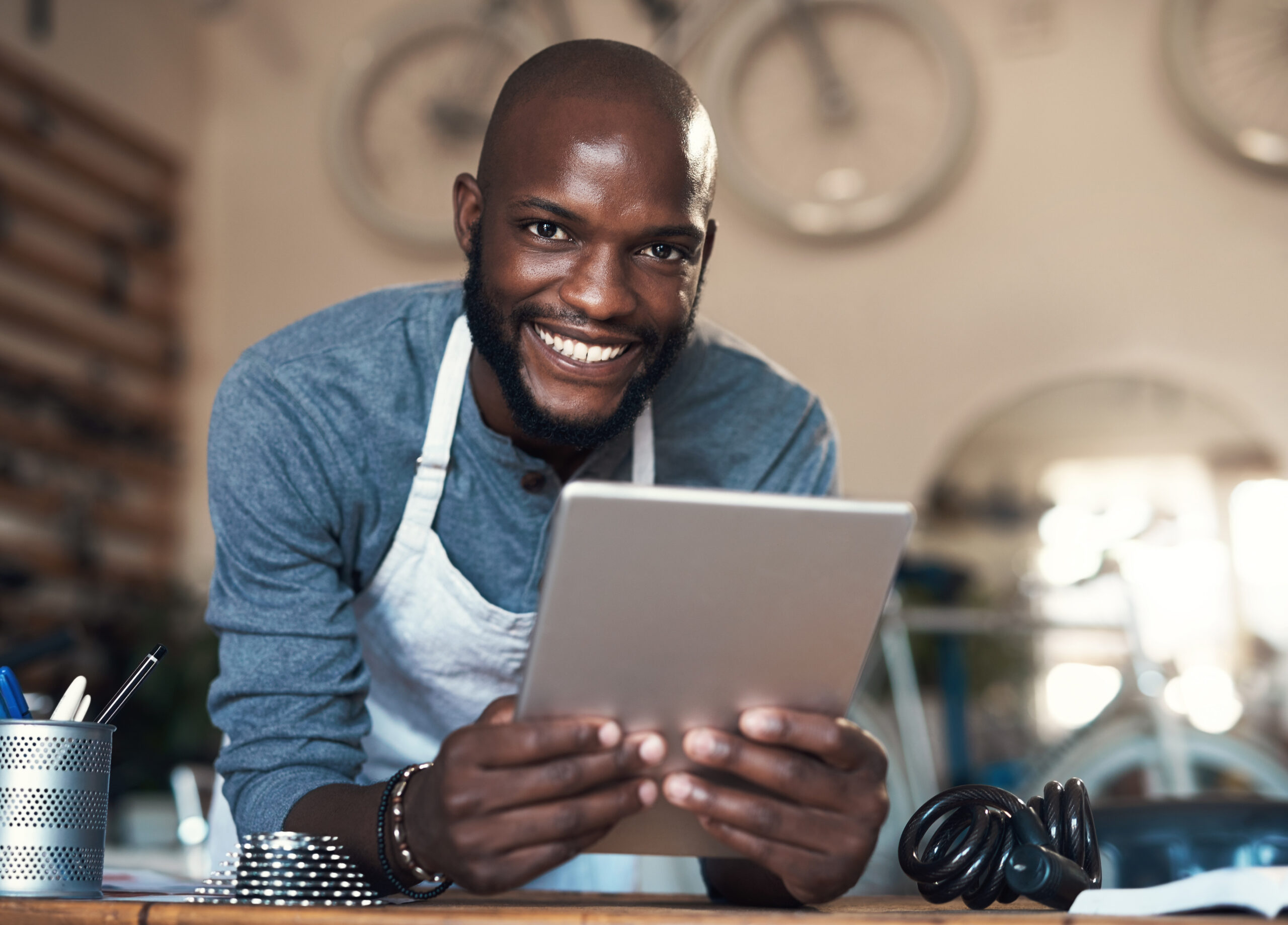 As dedicated as white on rice. Portrait of a young man using a digital tablet at work